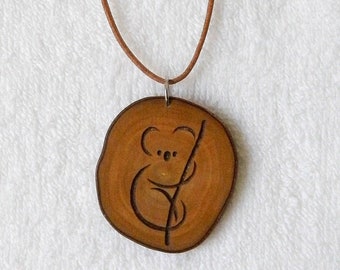 Olive branch wood pendant with stylized koala engraving with natural leather cord