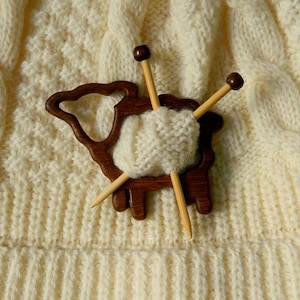 Teak wood brooch in the shape of a sheep with miniature knitting needles