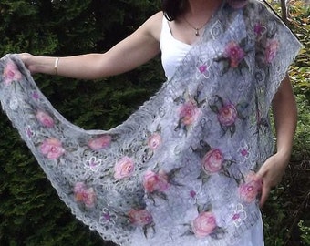 May include: A white shawl with a delicate floral pattern in shades of pink and gray. The shawl is made of a soft, lightweight fabric and is perfect for adding a touch of elegance to any outfit.