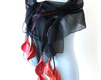 May include: A black sheer scarf with red felt flower accents. The scarf is draped over a white mannequin.