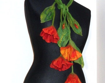May include: A felted wool necklace with red and orange flowers and green leaves. The necklace is tied in a knot at the top.