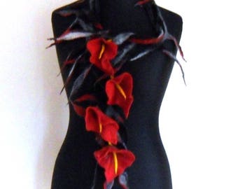 May include: A black and gray felted scarf with red and yellow flowers. The scarf is draped around a black mannequin.