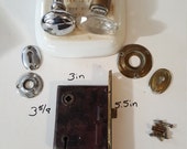 Salvaged crystal and chrome doorknobs with mortise and key hole covers.