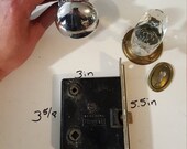 Salvaged crystal and chrome doorknobs with mortise and key hole covers.
