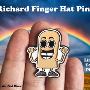 May include: A Richard Finger Hat Pin featuring a tan, cartoon-style finger character with large black eyes, a wide mouth with two teeth, and dark shoes. The pin includes the text Richard Finger Hat Pins and Limited To 100 Pieces.