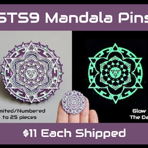May include: Two STS9 Mandala pins are displayed, one in daylight and one glowing in the dark. The daylight pin features a purple, white, and green design. The glow-in-the-dark pin has a green design on a black background. The text reads "Limited/Numbered to 25 pieces."