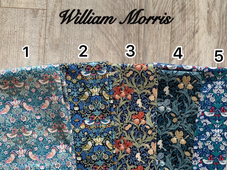 May include: Five fabric swatches with floral and bird patterns in various colors. The text "William Morris" is above the swatches. The fabrics feature designs with birds, flowers, and foliage in shades of blue, green, red, and cream.