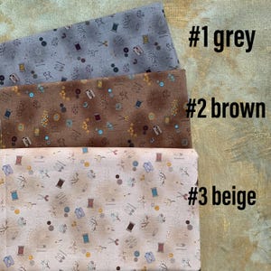 May include: Three fabric swatches in grey, brown, and beige, each patterned with sewing notions like spools, scissors, and pins. The swatches are labeled #1 grey, #2 brown, and #3 beige.