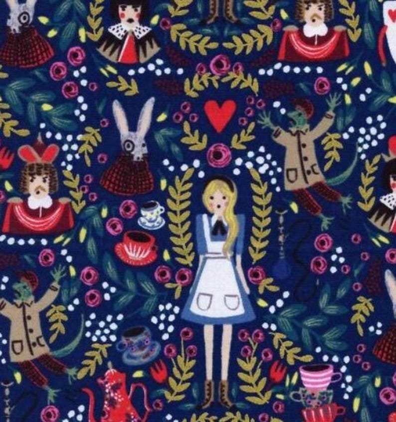May include: A fabric with a repeating pattern featuring characters and elements from Alice in Wonderland. The design includes Alice, the White Rabbit, teacups, roses, and other whimsical illustrations on a dark blue background.