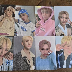 May include: A set of 10 photo cards featuring different portraits of young men. The cards are printed on white cardstock and have a glossy finish. Each card features a different pose and expression. The cards are perfect for fans of K-pop.