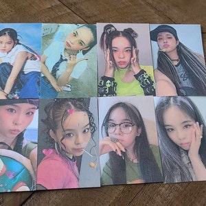 May include: Set of eight photo cards featuring different women with various hairstyles and clothing. The cards are printed on a textured paper with a grainy effect.