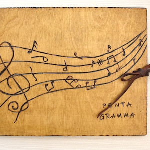 Quaderno di composizione musicale, pentagramma, in pelle e legno decorato con pirografia realizzata a mano.