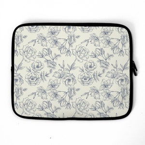 May include: A laptop sleeve with a white background and a blue floral pattern. The flowers are drawn in a simple, elegant style.