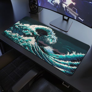May include: A blue and white pixelated wave design on a black gaming mouse mat. The mouse mat is on a black desk with a computer monitor and a speaker.