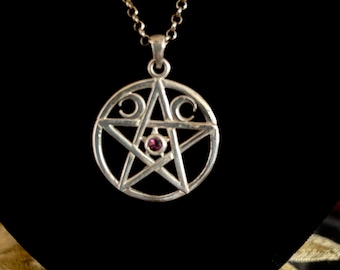 May include: A silver pendant necklace featuring a pentagram with a purple gemstone in the center. The pentagram is surrounded by three crescent moons.