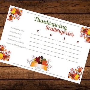 Op de afbeelding: Een printbaar Thanksgiving Scattergories-spel met een lijst van categorie&euml;n: Thanksgiving-eten, Herfstactiviteit, Ik ben dankbaar voor, Thanksgiving-traditie, Gevonden bij een voetbalwedstrijd. De categorie&euml;n staan onder de letters C, O, R en N. Het spel bevat een cartoon-kalkoen met een pelgrimhoed.