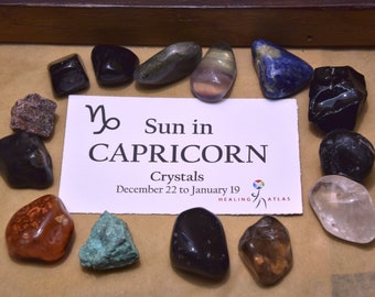 May include: A collection of crystals for Capricorn, a zodiac sign associated with the Sun in Capricorn from December 22 to January 19. The crystals are arranged in a circle around a card with the zodiac symbol and the text "Sun in Capricorn" and "Crystals December 22 to January 19".