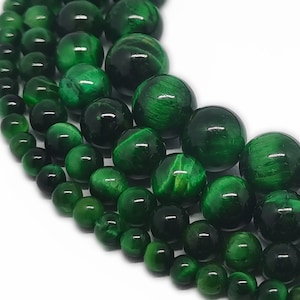 May include: A strand of green tiger's eye beads in various sizes. The beads are round and have a smooth, polished finish.