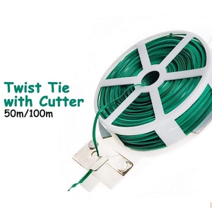 May include: A green twist tie with cutter on a white spool. The spool has a built-in cutter and is labeled "Twist Tie with Cutter 50m/100m".
