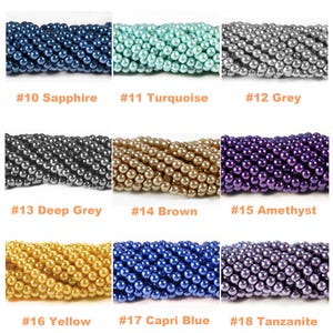 May include: Nine strands of round, lustrous beads arranged in a grid. Colors include sapphire, turquoise, grey, deep grey, brown, amethyst, yellow, capri blue, and tanzanite. Each strand is labeled with a number from 10 to 18 and its color name.