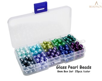 May include: A clear plastic storage box filled with 8mm glass pearl beads in 8 different colors. Each compartment contains 25 beads. The box has a blue lid with a latch. The text on the box reads "Glass Pearl Beads 8mm Box Set 25pcs/color".