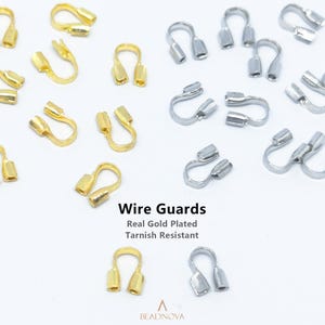 May include: A collection of U-shaped wire guards in gold and silver tones, arranged on a white background. The text Wire Guards, Real Gold Plated, Tarnish Resistant, and BEADNOVA is printed in the center. These metal findings are used for jewelry.