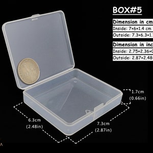 May include: A clear plastic storage box with a hinged lid. The box is 7 cm long, 6 cm wide, and 1.4 cm tall. The box is 7.3 cm long, 6.3 cm wide, and 1.7 cm tall.