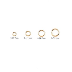 May include: Four gold jump rings in different sizes. The rings measure 0.64 x 3 mm, 0.64 x 4 mm, 0.64 x 5 mm, and 0.76 x 6 mm.