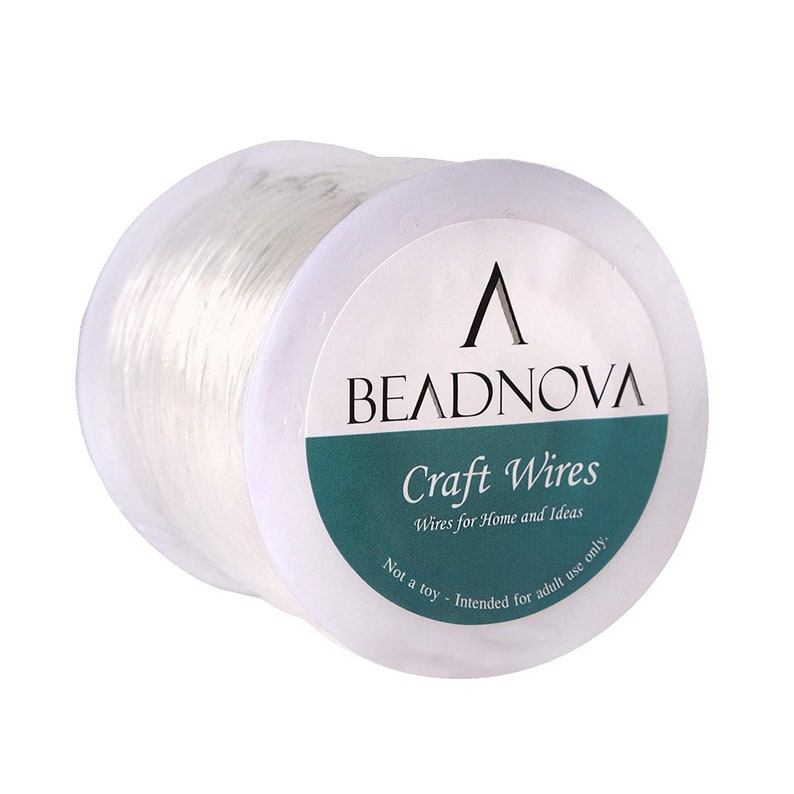 May include: A spool of clear elastic beading wire with a white label that reads "Beadnova Craft Wires, Wires for Home and Ideas, Not a toy - Intended for adult use only."