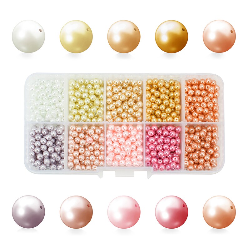 May include: A clear plastic organizer filled with various colors of faux pearls. The pearls range in size and color, including white, gold, bronze, and pink. The top row features larger pearls, while the rest of the organizer contains smaller beads.