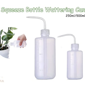 May include: Two clear plastic squeeze bottles with long, thin spouts. The bottles are marked with measurements in milliliters, and the larger bottle is labeled 500ml. The smaller bottle is labeled 250ml. The bottles are used for watering plants.