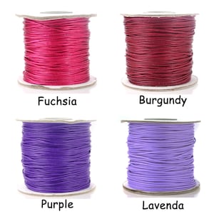 May include: Four spools of waxed cotton cord in different colors: fuchsia, burgundy, purple, and lavender.