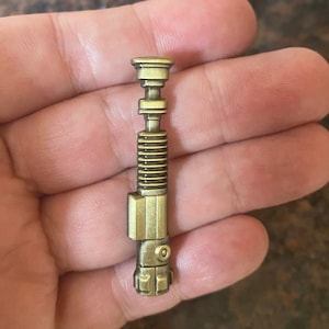 Star Wars Obi Wan Kenobi Lightsaber die cast pin badge.