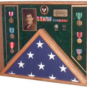 May include: A wooden shadow box with a folded American flag, a framed photo of a man in military uniform, and a collection of medals and ribbons. The text on the plaque reads "Henry Gambello, Exemplary Military Service, United States Army".