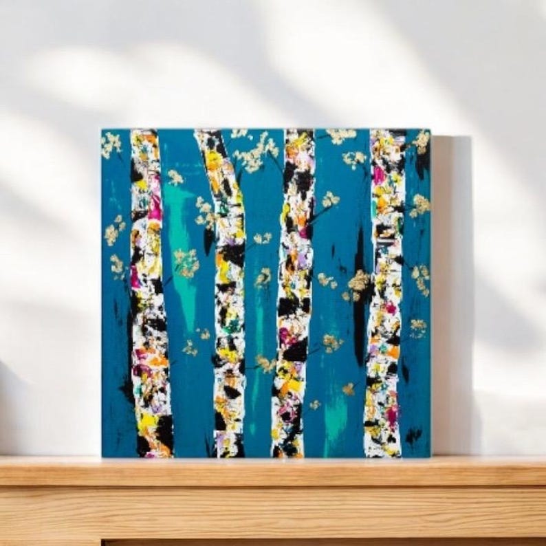 May include: Abstract painting of a forest scene with white birch trees on a teal blue background. The trees are painted with colorful details and gold accents.