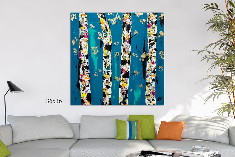 May include: Abstract painting of birch trees with a teal background. The trees are painted in white, black, yellow, pink, and gold. The painting is 36 inches by 36 inches.