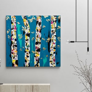 May include: Abstract painting of a forest scene with colorful trees on a teal background. The trees are painted in a stylized manner with white, black, and gold accents.