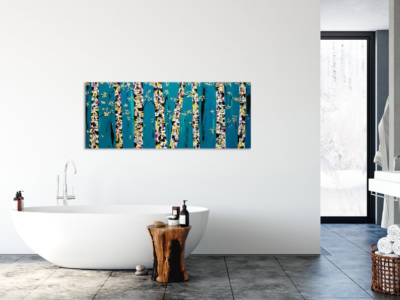 May include: Abstract painting of a forest scene with teal, yellow, white, and black colors. The painting is hanging on a white wall in a bathroom setting.
