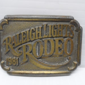 Vintage RJ Solid Brass Commemorative Belt Buckle &quot;Raleigh Lights Rodeo 1981&quot;