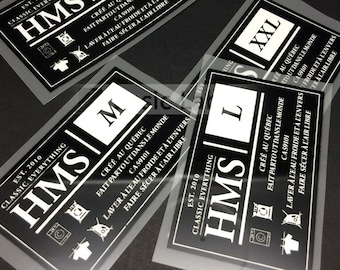 May include: Four black and white clothing labels with the text "HMS" and "EST. 2010 CLASSIC EVERYTHING" on each label. The labels are for different sizes: S, M, L, and XXL. Each label includes instructions for washing and drying the garment.