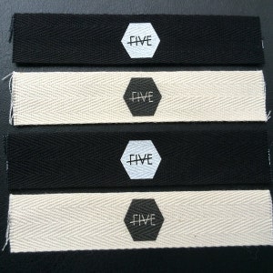 May include: Four fabric samples with a black and white hexagonal logo that says "FIVE" on each sample. Two samples are black and two samples are a natural off-white color.