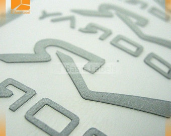 May include: Close-up of a silver, textured, embossed label with the number "500" printed on it.