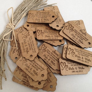 May include: A pile of wooden tags with a heart design and the text "Aloha, Welcome to Hawaii. Thanks for being part of our special day. Dale & Mike 18th July 2013" on each tag.