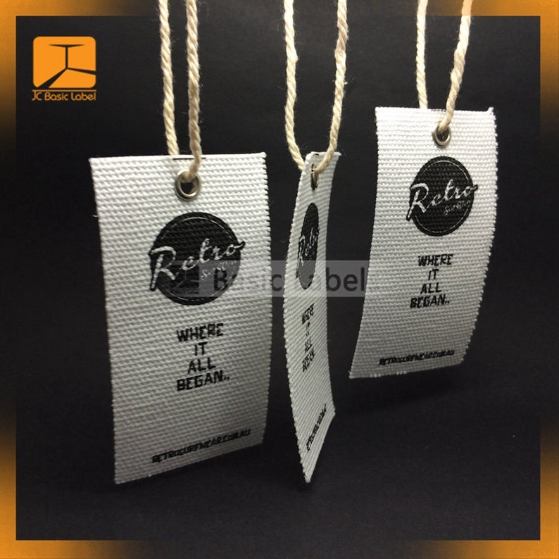 Puede incluir: Tres etiquetas de tela blanca con texto negro y un logotipo circular negro que dice "Retro" con una peque&ntilde;a "B" dentro del c&iacute;rculo. El texto en las etiquetas dice "Where it all began." y "retrosurfwear.com.au".