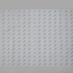 May include: White tissue paper with a repeating pattern of blue text that says "Made in USA".