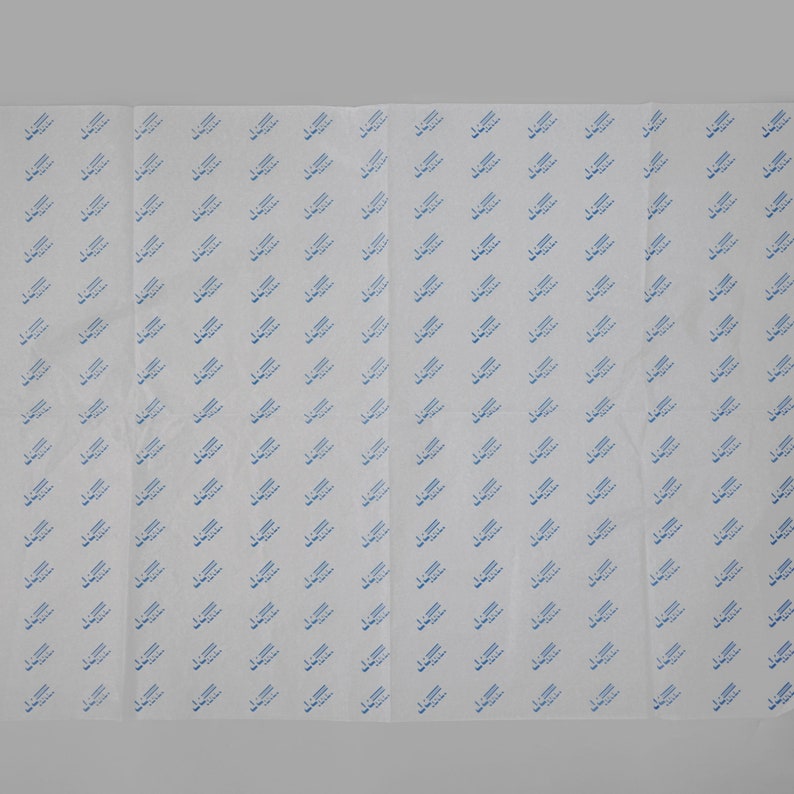 May include: White tissue paper with a repeating pattern of blue text that says "Made in USA".