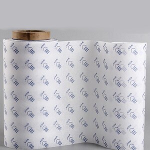 May include: A roll of white tissue paper with a repeating pattern of blue footprints. The footprints have the text "613 m" inside.