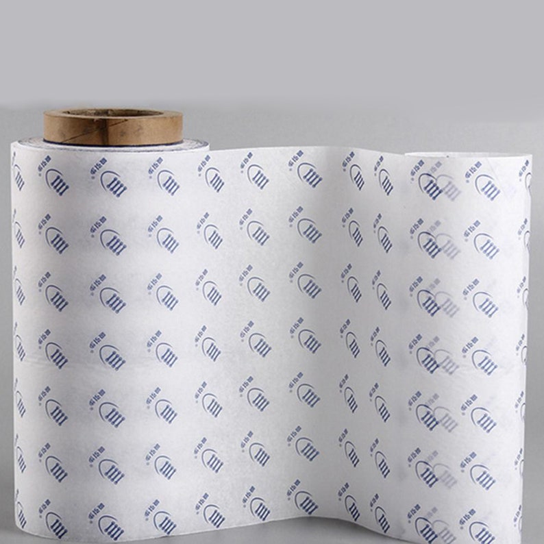 May include: A roll of white tissue paper with a repeating pattern of blue footprints. The footprints have the text "613 m" inside.