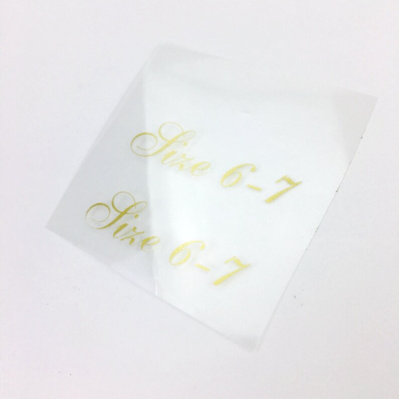 May include: Two clear plastic stickers with gold lettering that reads "Size 6-7".
