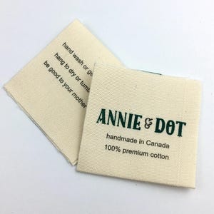 May include: A white fabric label with green text that reads "ANNIE & DOT handmade in Canada 100% premium cotton".